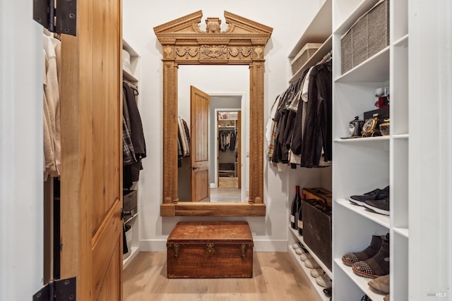 mudroom with baseboards and wood finished floors