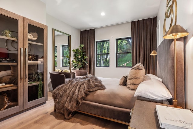 bedroom featuring light wood-style flooring and recessed lighting