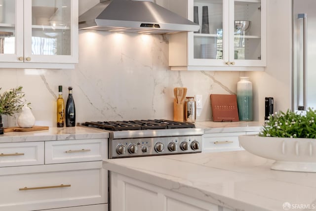 192 Yerba Buena Ave, San Francisco, CA 94127 - kitchen with under cabinet range hood, white cabinetry, tasteful backsplash, stainless steel gas cooktop, and glass insert cabinets