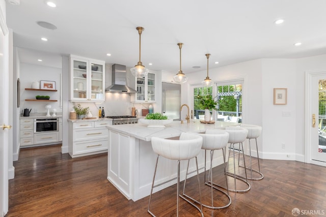 192 Yerba Buena Ave, San Francisco, CA 94127 - kitchen featuring wall chimney exhaust hood, white cabinets, plenty of natural light, light stone countertops, and recessed lighting