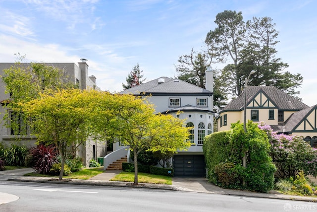192 Yerba Buena Ave, San Francisco, CA 94127 - view of front facade with stucco siding, a chimney, and an attached garage