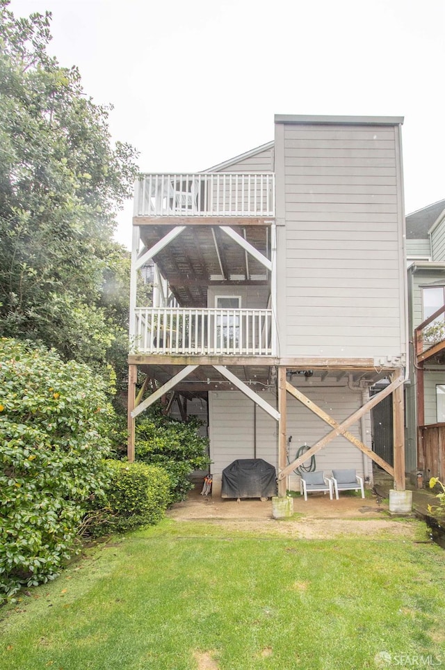 rear view of property with a lawn