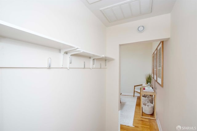 walk in closet featuring light wood-type flooring and visible vents