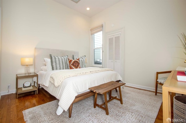 bedroom featuring recessed lighting, a closet, baseboards, and wood finished floors