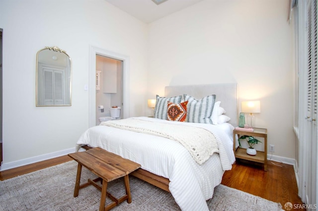 bedroom featuring baseboards and wood finished floors