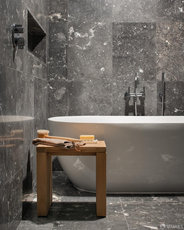 bathroom with a bathtub and tile walls