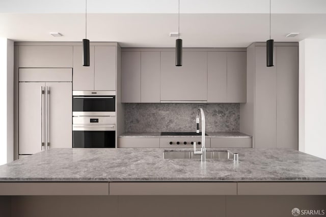 kitchen with double oven, pendant lighting, gray cabinets, and paneled built in refrigerator