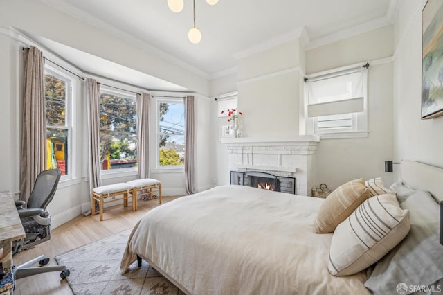 411 Clipper St, San Francisco, CA 94114 - bedroom with wood finished floors, ornamental molding, baseboards, multiple windows, and a brick fireplace
