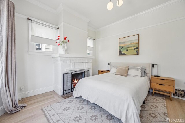 411 Clipper St, San Francisco, CA 94114 - bedroom featuring wood finished floors, crown molding, a brick fireplace, and baseboards