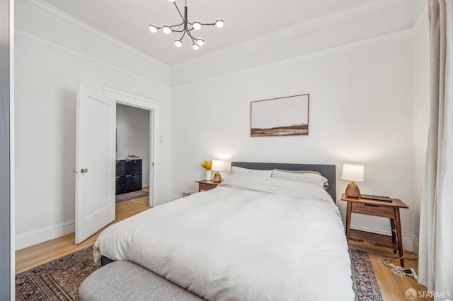 411 Clipper St, San Francisco, CA 94114 - bedroom featuring wood finished floors, a chandelier, crown molding, and baseboards