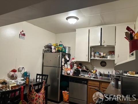 kitchen with sink, white cabinetry, and stainless steel appliances