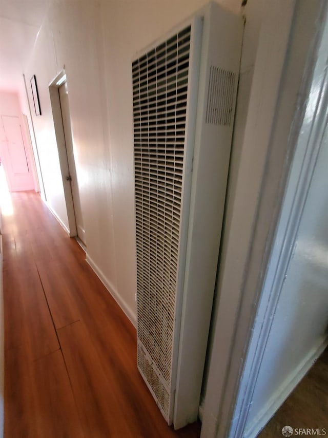 corridor with hardwood / wood-style flooring