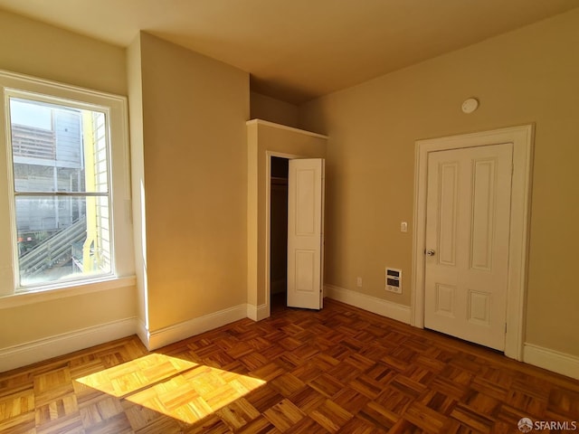 interior space featuring dark parquet flooring and heating unit