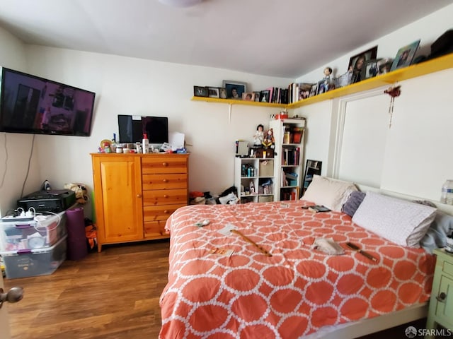 bedroom with hardwood / wood-style flooring