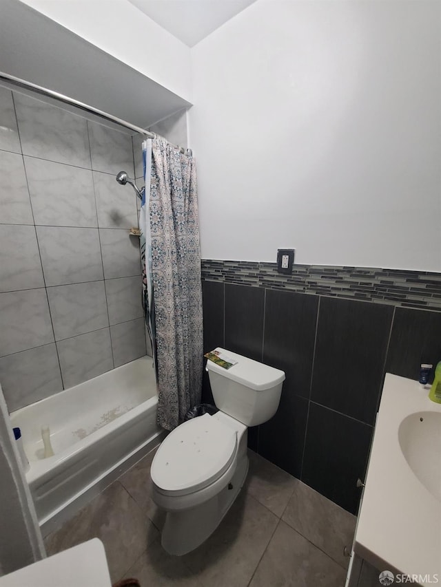 bathroom with tile patterned floors, a shower with curtain, tile walls, and toilet