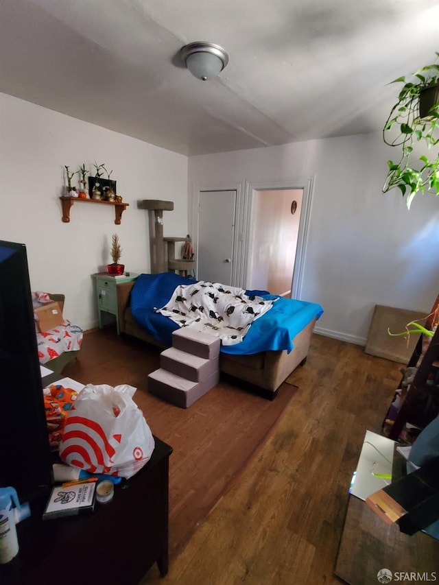 bedroom with dark hardwood / wood-style floors