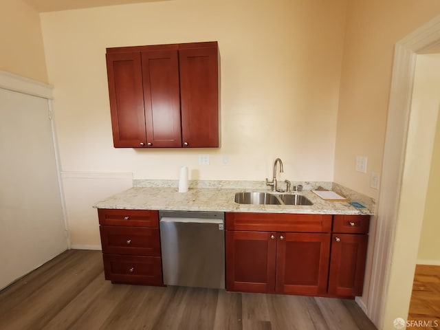 kitchen featuring dishwasher, light hardwood / wood-style floors, light stone countertops, and sink