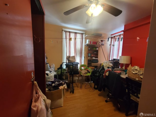 miscellaneous room featuring ceiling fan and light hardwood / wood-style floors