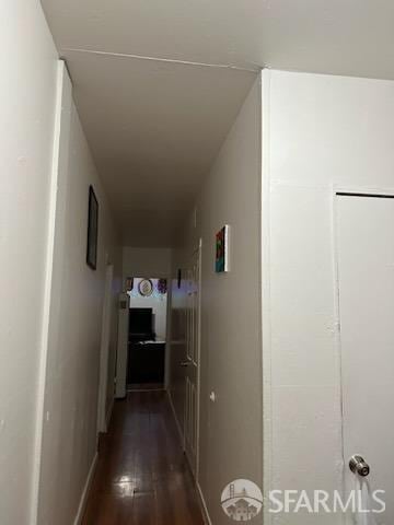 hallway with dark hardwood / wood-style flooring