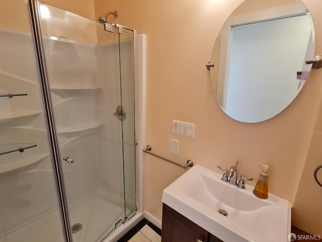 bathroom featuring tile patterned flooring, vanity, and a shower with shower door