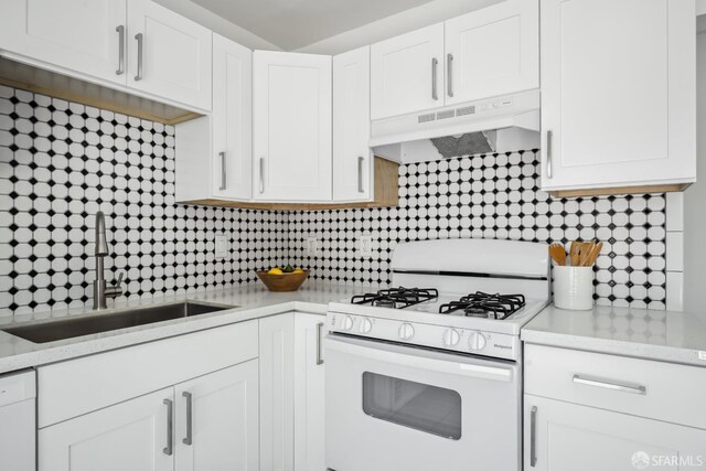 212 Kavanaugh Way, Pacifica, CA 94044 - kitchen with white gas stove, under cabinet range hood, white cabinetry, and decorative backsplash