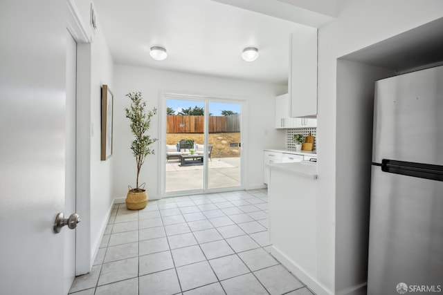 212 Kavanaugh Way, Pacifica, CA 94044 - kitchen featuring freestanding refrigerator, white cabinetry, light countertops, light tile patterned floors, and decorative backsplash