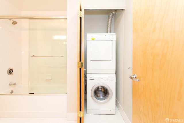 clothes washing area featuring stacked washing maching and dryer