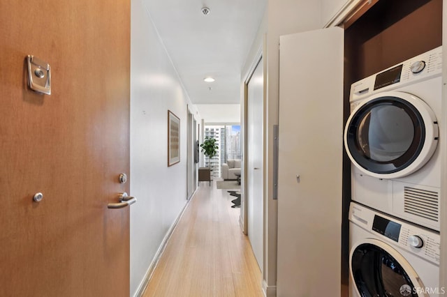 425 1st St Unit 2007, San Francisco, CA 95105 - laundry area featuring stacked washing machine and dryer, light wood-style floors, and recessed lighting
