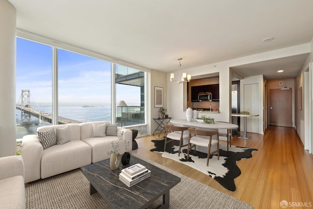 425 1st St Unit 2007, San Francisco, CA 95105 - living room featuring a chandelier, a water view, light wood finished floors, and expansive windows