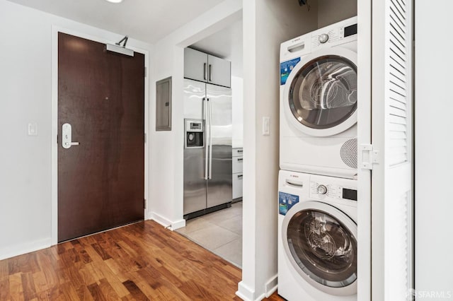 555 4th St Unit 636, San Francisco, CA 94107 - laundry room with stacked washing machine and dryer, light wood finished floors, and electric panel