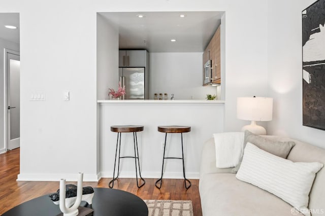 555 4th St Unit 636, San Francisco, CA 94107 - kitchen with stainless steel appliances, wood finished floors, a breakfast bar, recessed lighting, and a peninsula