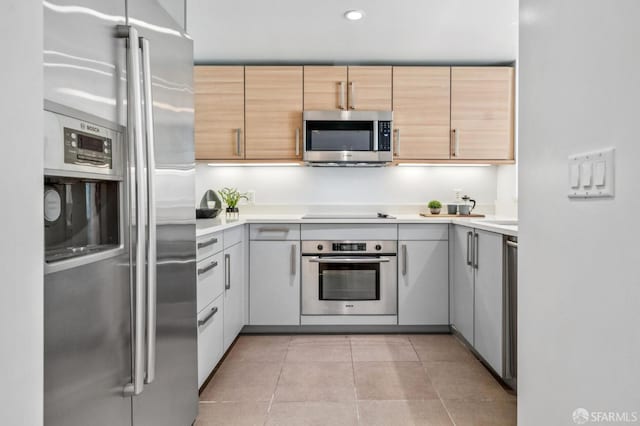 555 4th St Unit 636, San Francisco, CA 94107 - kitchen with appliances with stainless steel finishes, light countertops, recessed lighting, light tile patterned floors, and light brown cabinets