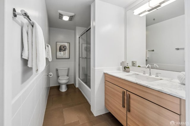 555 4th St Unit 636, San Francisco, CA 94107 - bathroom with vanity, enclosed tub / shower combo, wainscoting, tile patterned flooring, and tile walls
