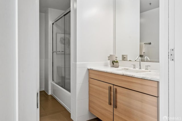 555 4th St Unit 636, San Francisco, CA 94107 - bathroom with vanity, tile patterned floors, and bath / shower combo with glass door