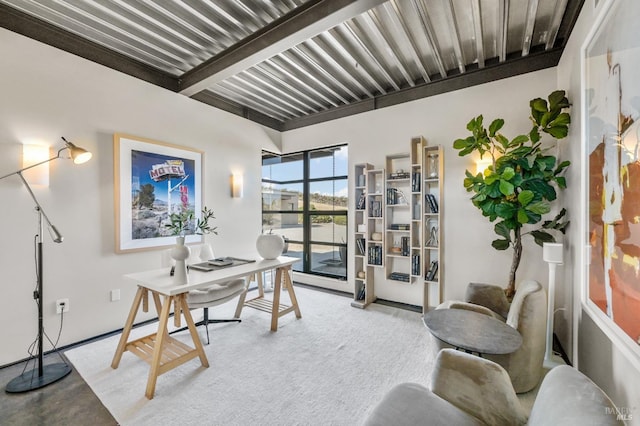 office space featuring concrete floors and beamed ceiling