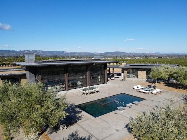 view of pool featuring a patio and a mountain view