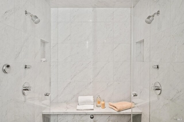 full bathroom with a marble finish shower