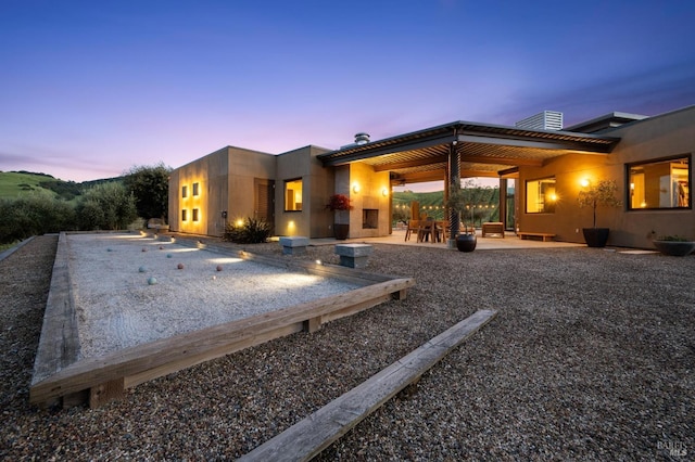 back of property with a patio area and stucco siding