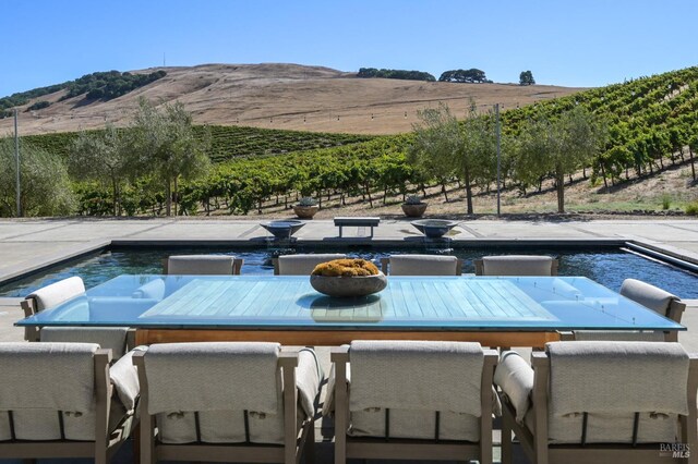 exterior space with a mountain view, a patio, and a rural view