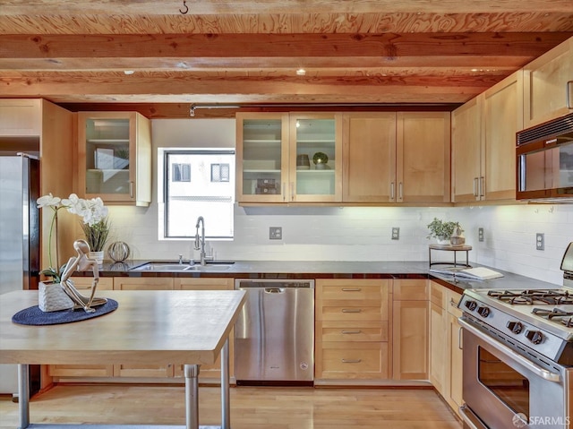 kitchen with beamed ceiling, stainless steel appliances, light brown cabinetry, light hardwood / wood-style flooring, and sink