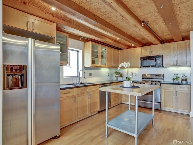 kitchen with light brown cabinets, sink, appliances with stainless steel finishes, and light hardwood / wood-style floors