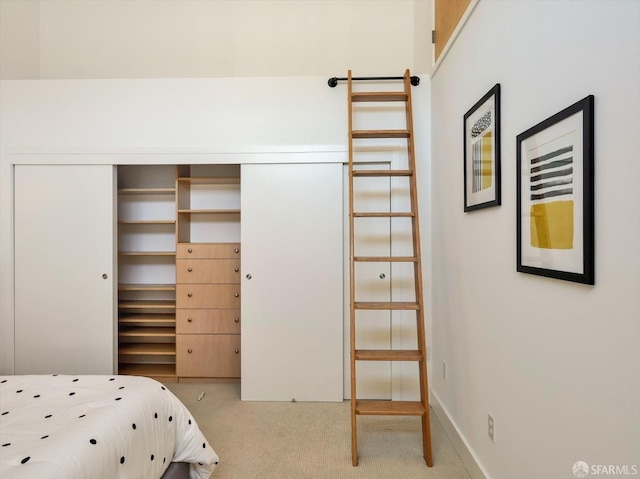 unfurnished bedroom featuring light carpet and a closet