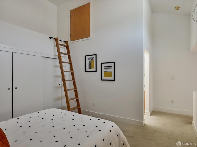 bedroom featuring a closet and light colored carpet