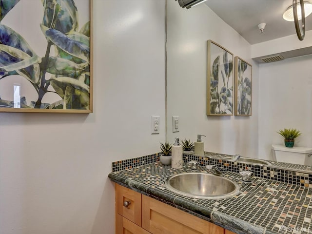 bathroom featuring vanity and toilet