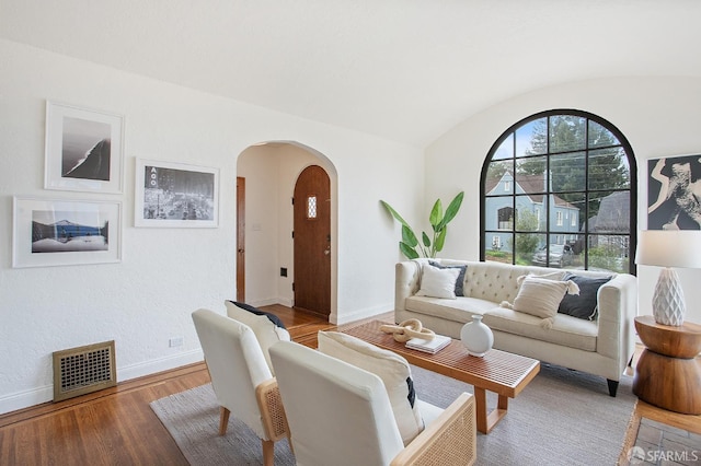 living room with wood-type flooring and lofted ceiling