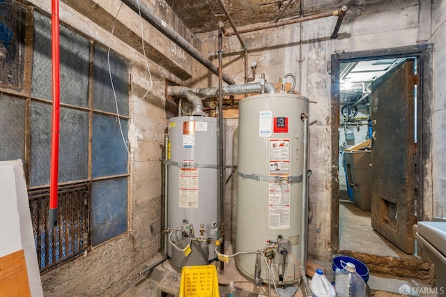 utility room featuring strapped water heater and water heater