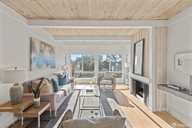 living room with hardwood / wood-style floors, wooden ceiling, and beam ceiling