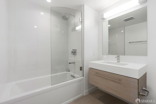 bathroom featuring tile patterned flooring, visible vents, shower / bath combination with glass door, and vanity