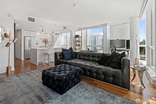 living room with visible vents and wood finished floors