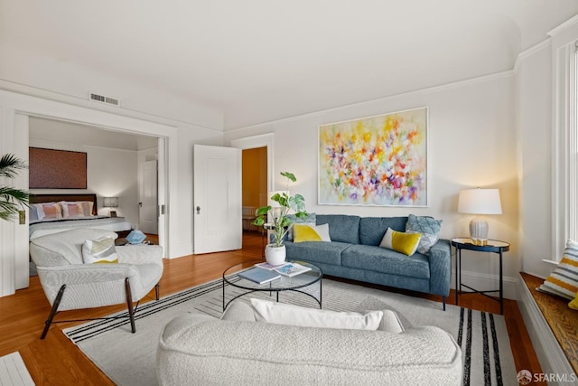 living room featuring visible vents and wood finished floors